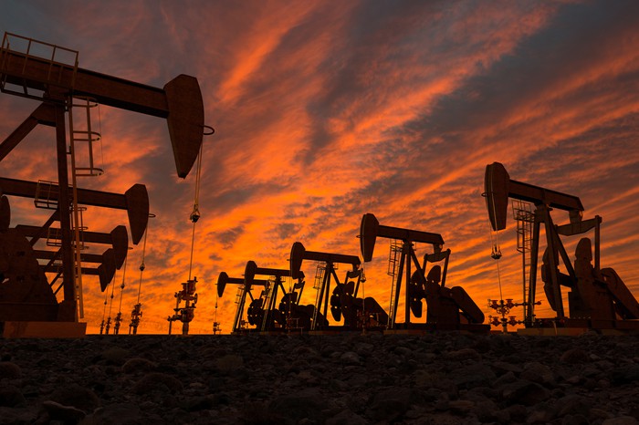 Oil slumps three percent, near lowest in a year as stock markets sink