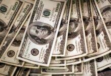 Dollar rises versus risky currencies as coronavirus surges, US stimulus hope fades