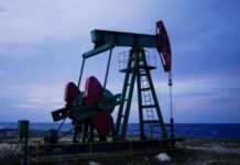 Oil eases on demand concerns after jump in US stockpiles