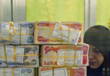 Iraq devalues dinar as oil prices squeeze revenues